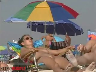A smart chick in a nude beach spy cam show
